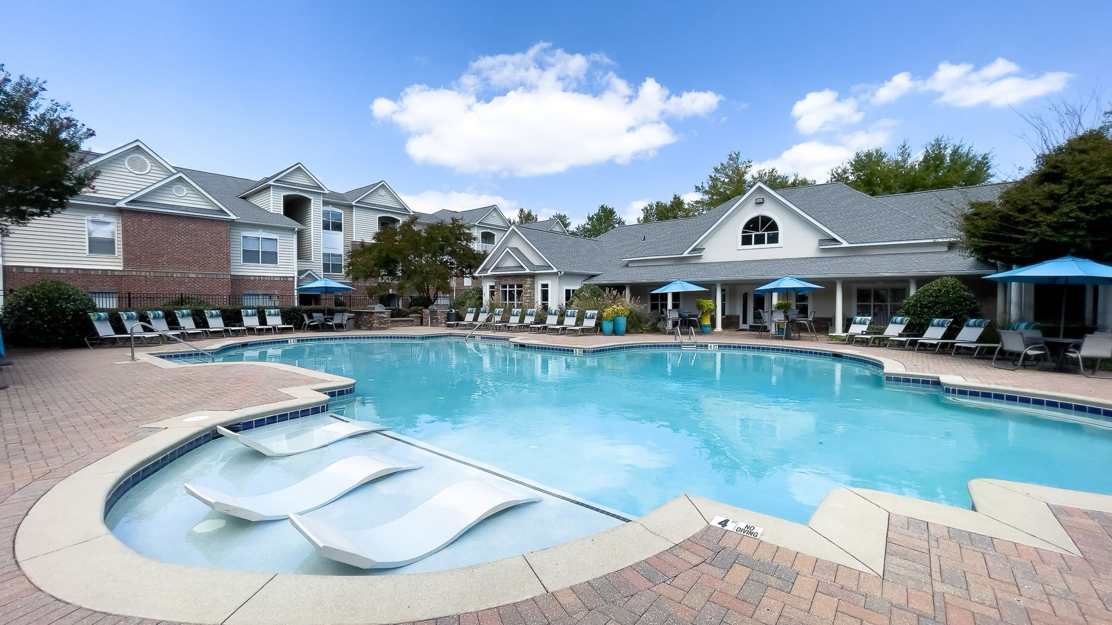 Hawthorne at Kennesaw luxury outdoor pool with in-pool lounge chairs and surrounding seating