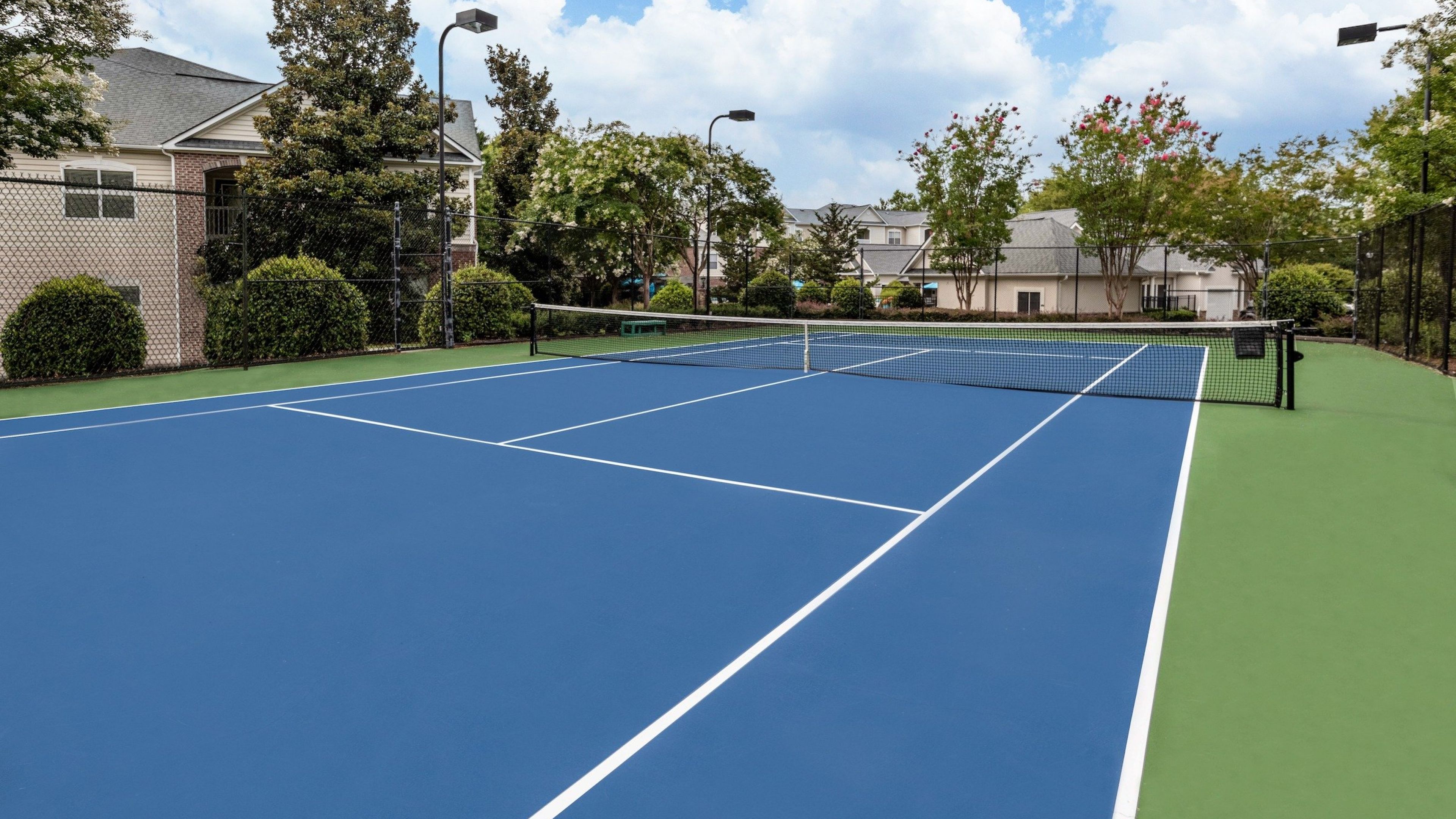 outdoor tennis court and surrounding landscaping